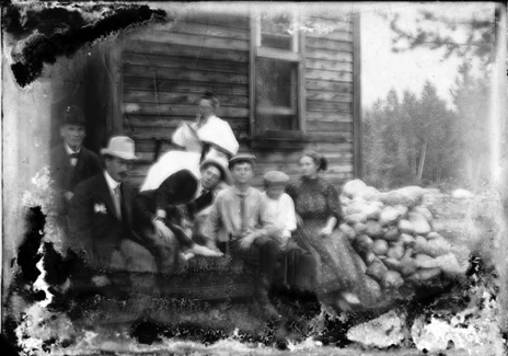 Print from glass plate negative. Jones family, left to right: George, Clarence Victor, Raye, LaDora, Robert, GWI and Ben. Location unknown.